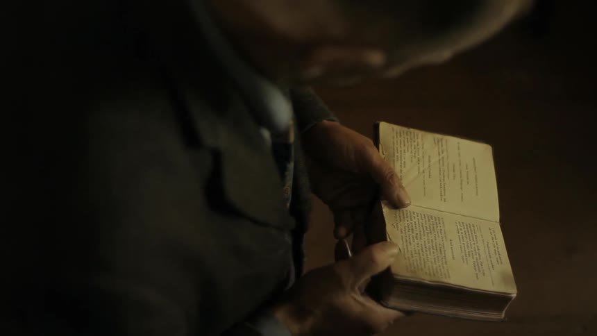 A man reading an old book