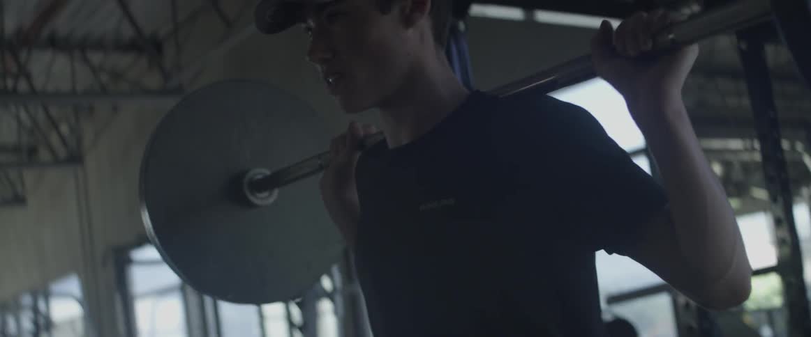 A man lifts weights in a gym