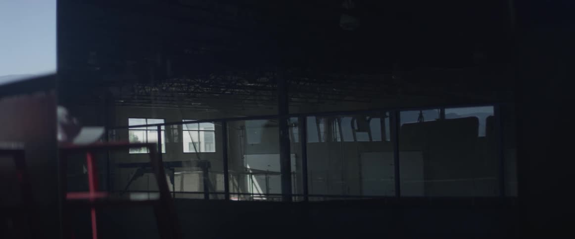 A man runs in a dark gym