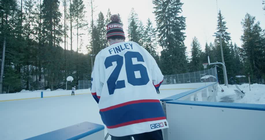 A hockey player is skating onto the ice
