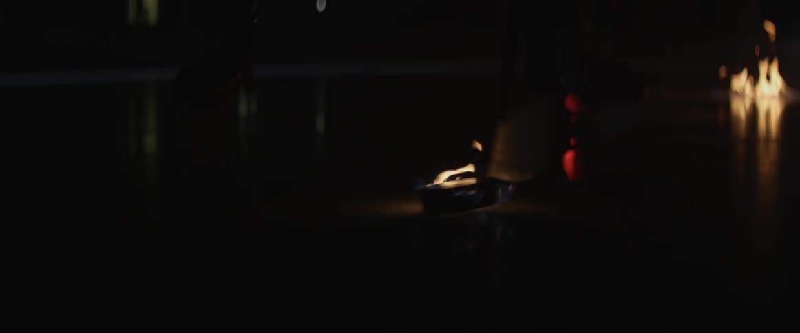 A flaming hockey puck is bounced across the floor
