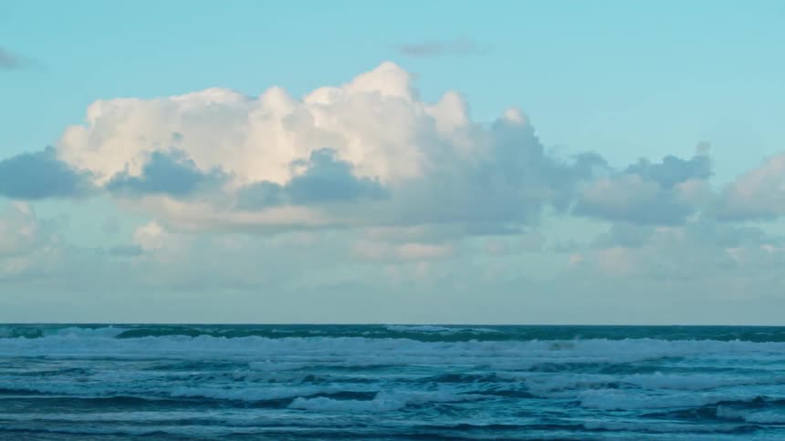 Waves crest and roll toward the shore during the day