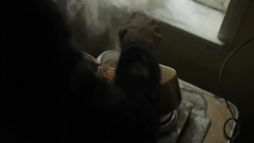Tea is made near a window with a lace curtain