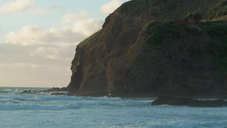 Ocean waves rolling up on rocky cliffs