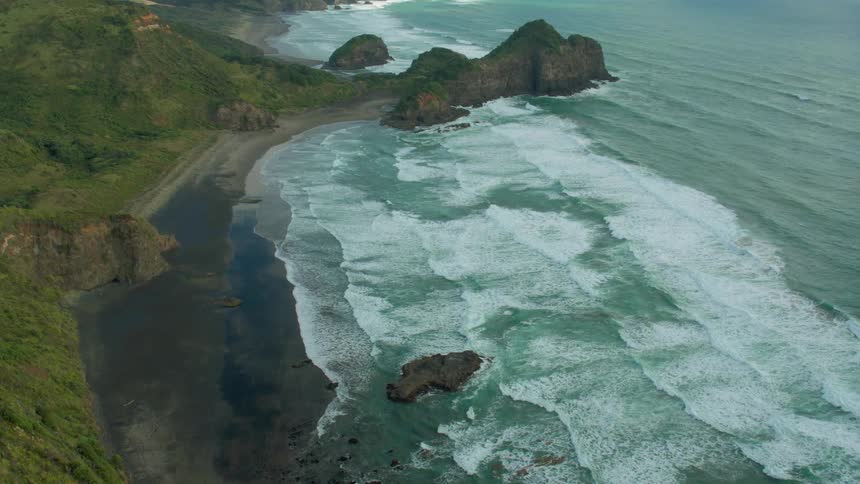 Clouds hover over a beach and rocky coastline