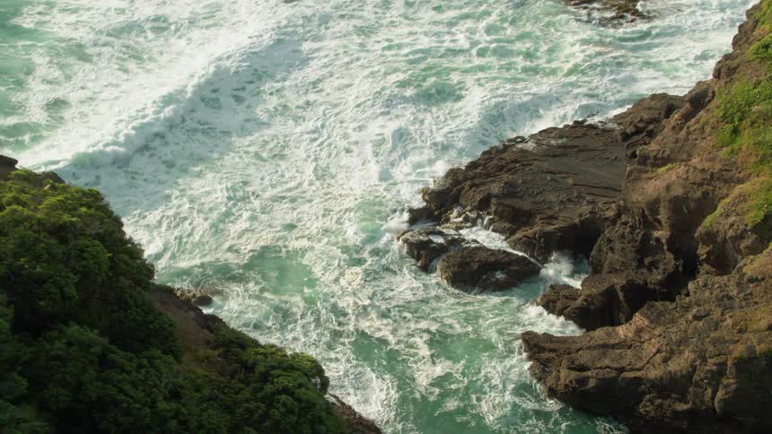 Ocean waves rolling up on rocky cliffs