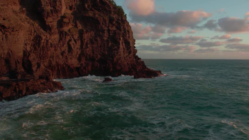 Waves crashing against a large rock