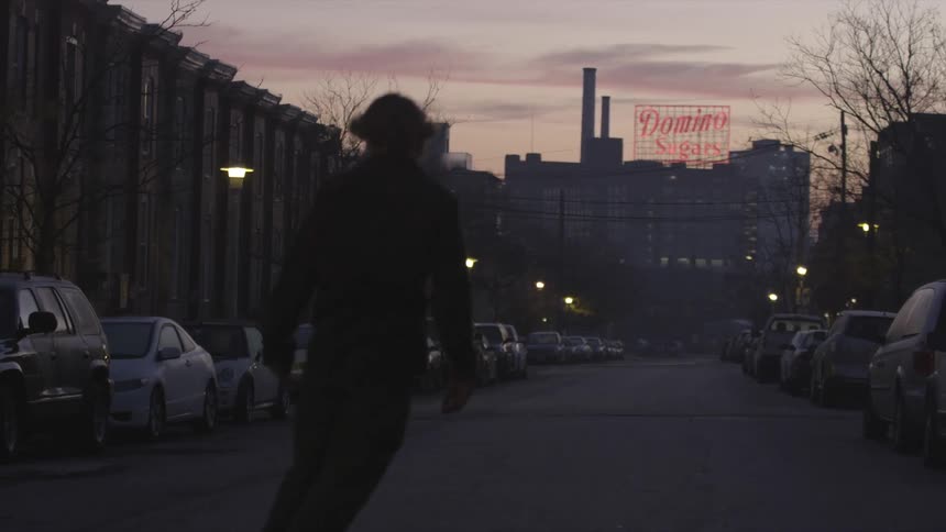 Person rolling down a street at sunset