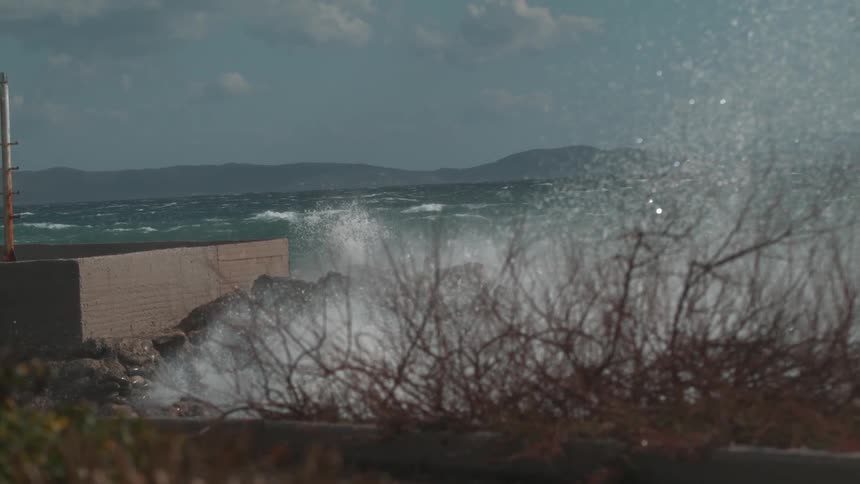 Waves crash along a shore