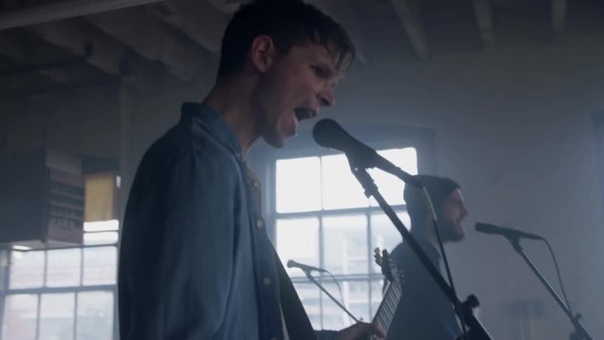 A rock band performs in a room