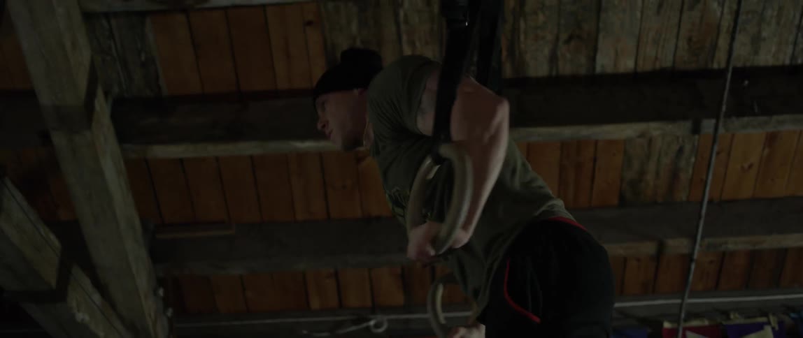 A man works out using gymnastic rings