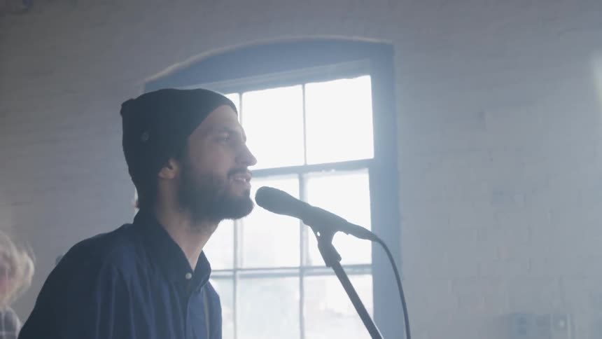 A band is playing music inside during the day