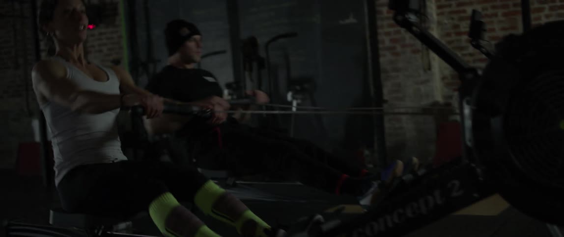 A couple using rowing machines