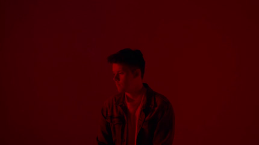Boy sits in red room