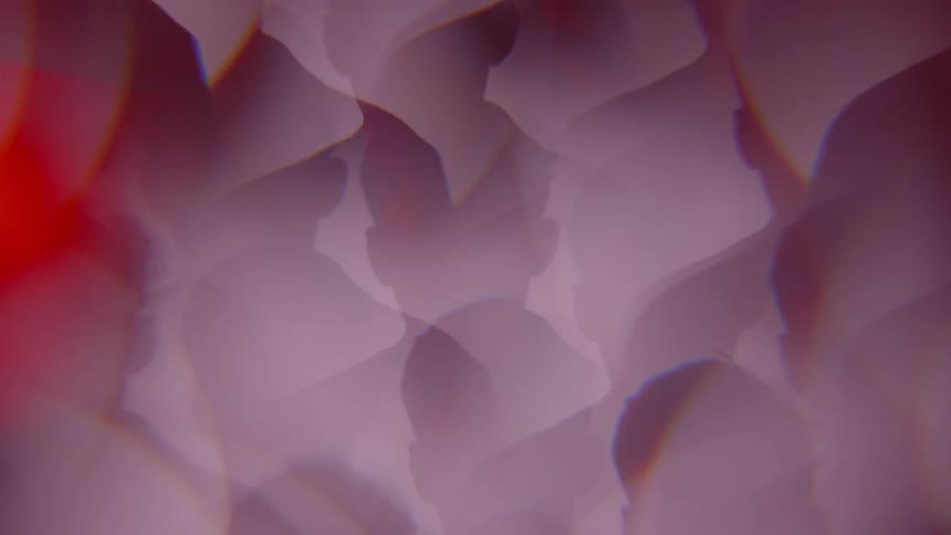 A man's image refracts and spins in abstract