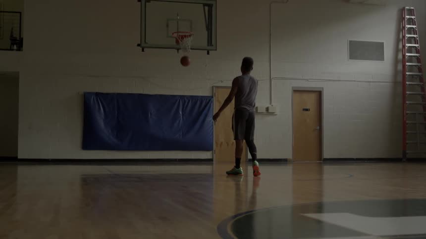 A basketball player is sinking a free throw