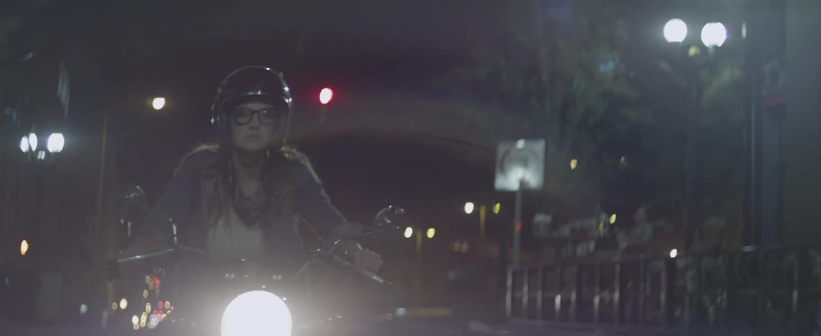 A woman rides a motorcycle