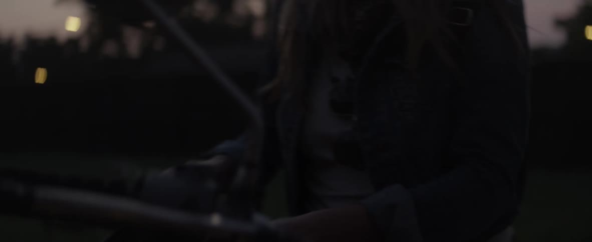 A woman turns the headlight on her motorcycle on