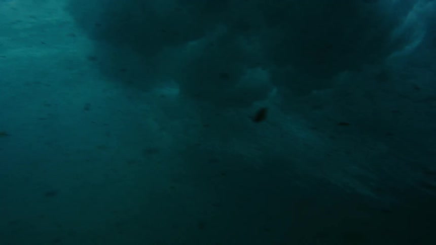 An ocean wave crashes down