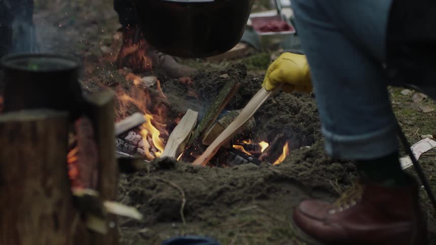 Man cooks over an open fire