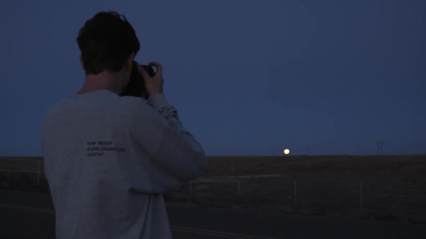 A photographer takes a photo in the desert