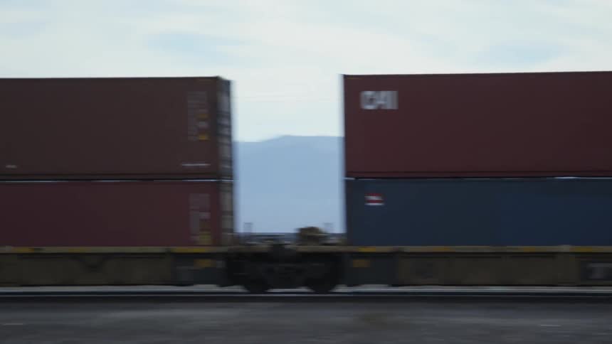 A train passes by a crossing with waiting cars