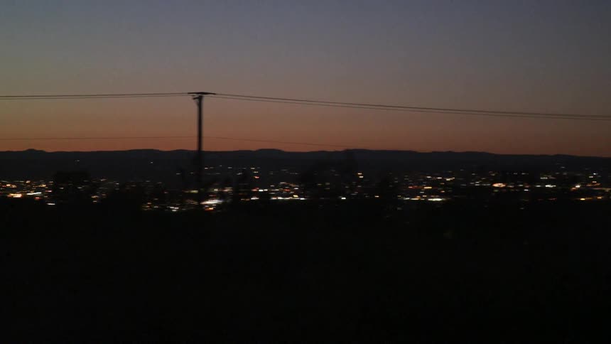 Darkness envelops a city under a clear sky