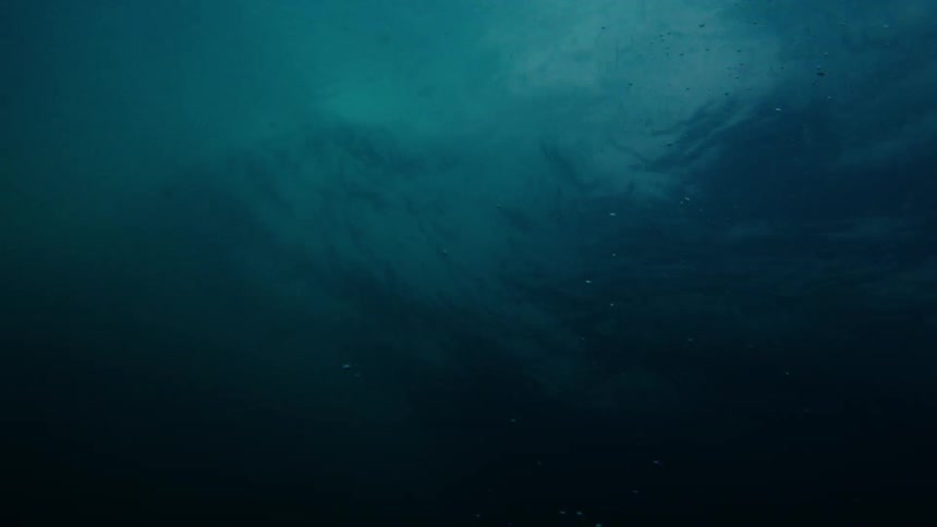 The action of the waves create bubbles beneath the ocean's surface
