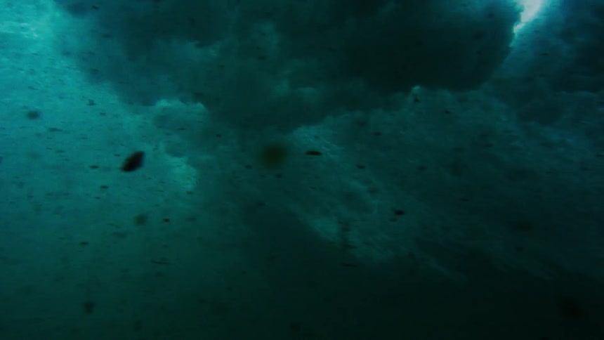 Waves stir up debris beneath the ocean's surface as they crash