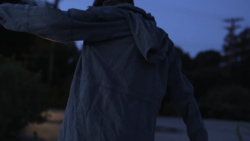 A man in a jacket sways on a building