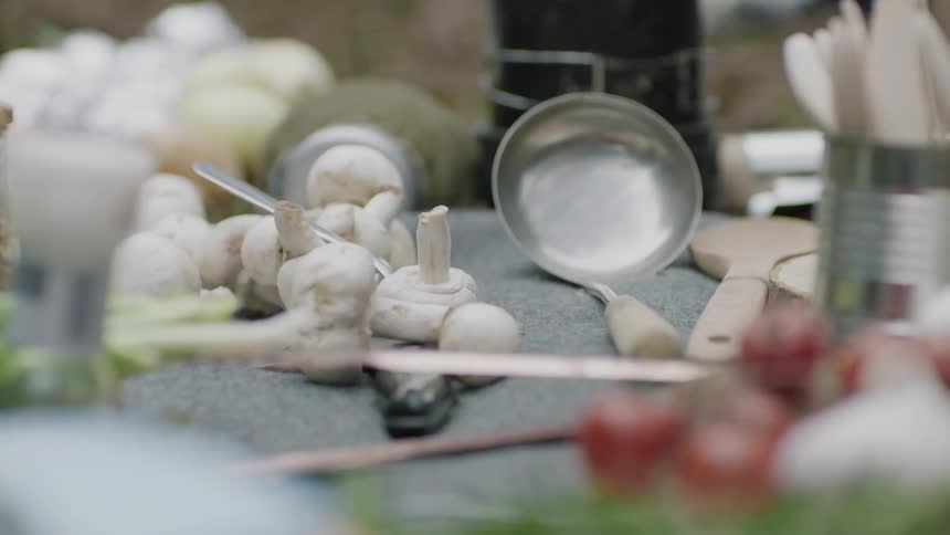 Garlic and kitchen utensils are scattered on a table