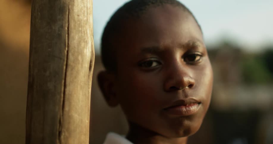 Boy stands outside on a clear day