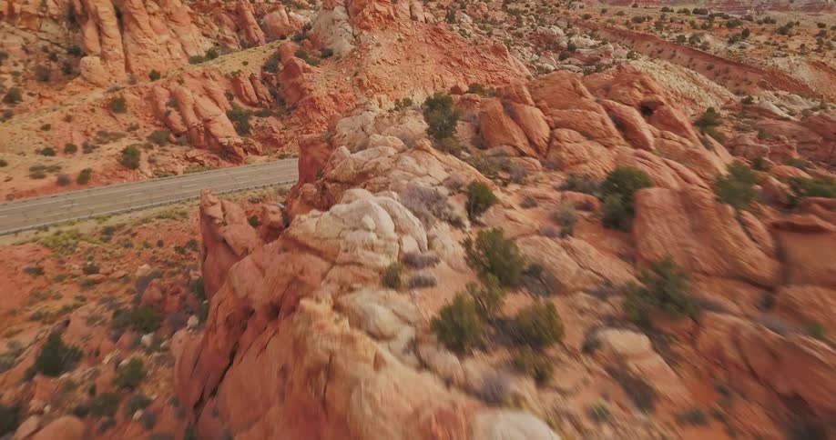 Shrubs scatter on a red clay mountain