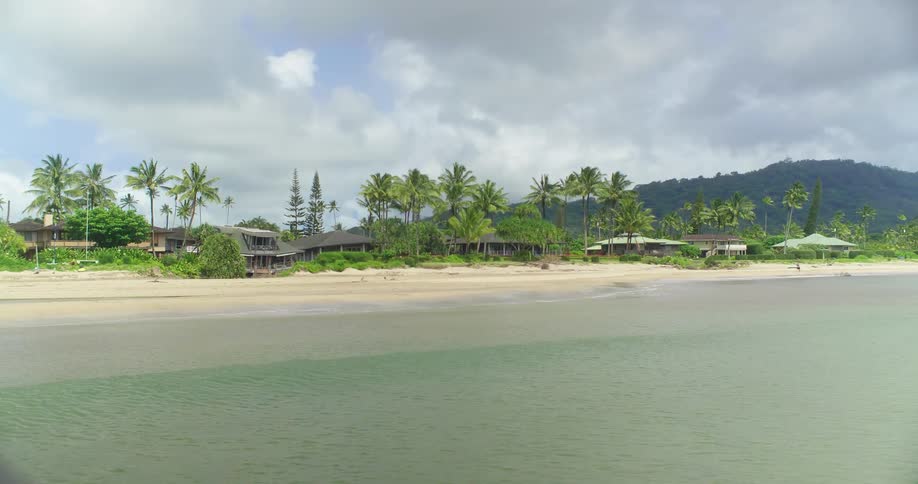 Waves roll onto the shore of a beach community