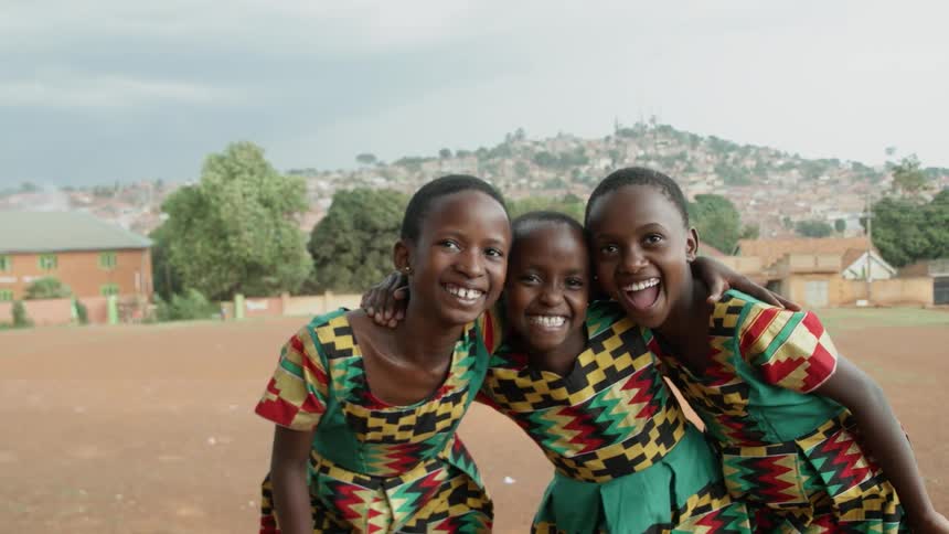 Three school children smile together