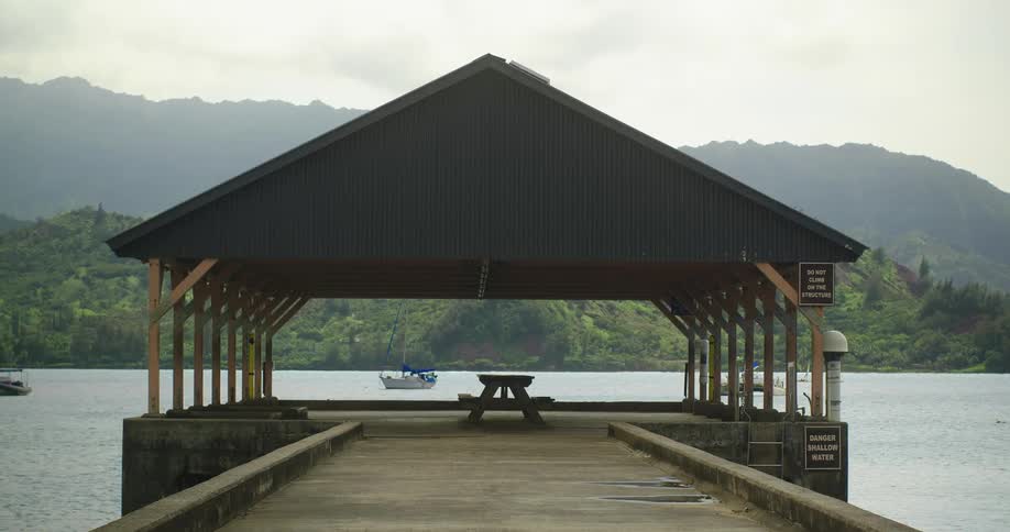 A picnic table sits on a lake pier