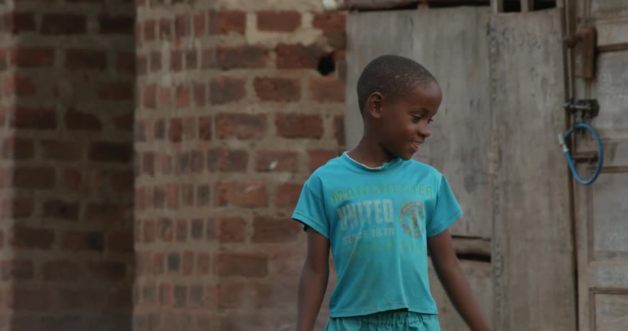 A little boy talks in front of a door