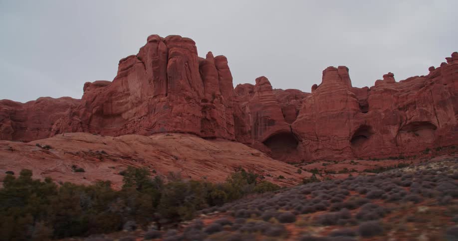Eroded sandstone cliffs form pillars in a desert