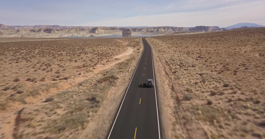 A car drives through a desert