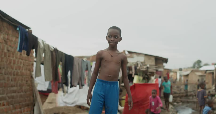 Young man stands near a clothes line filled with clothes