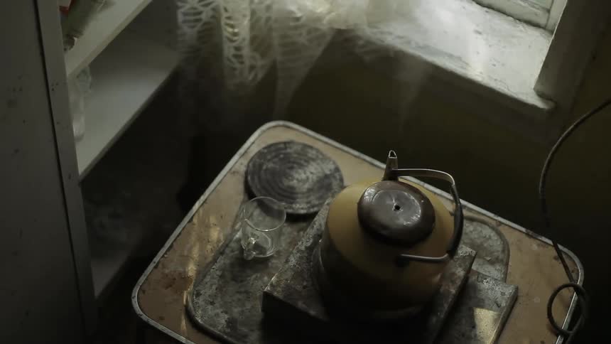 Overhead view of an old steaming water kettle
