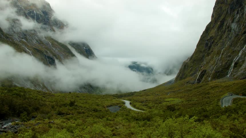 Clouds float in a mountain valley