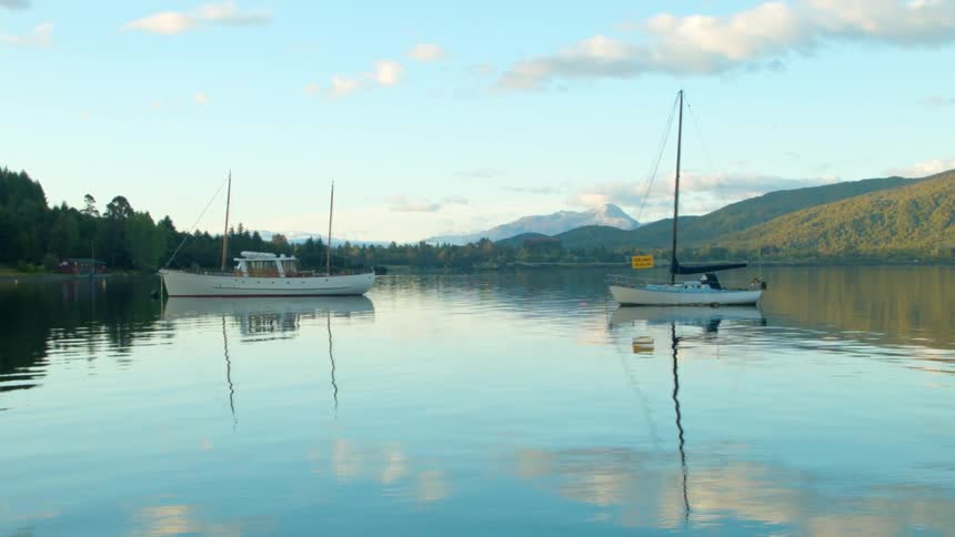 Boats float on a mountain lake