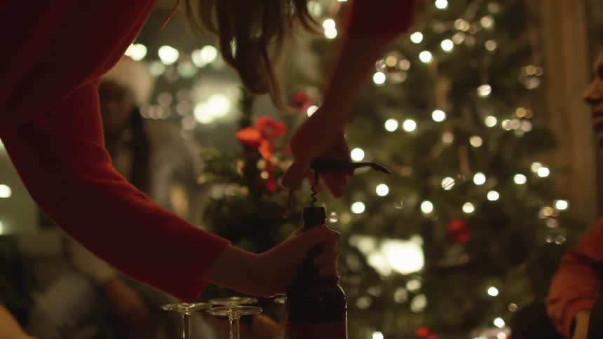 A person uncorking a bottle