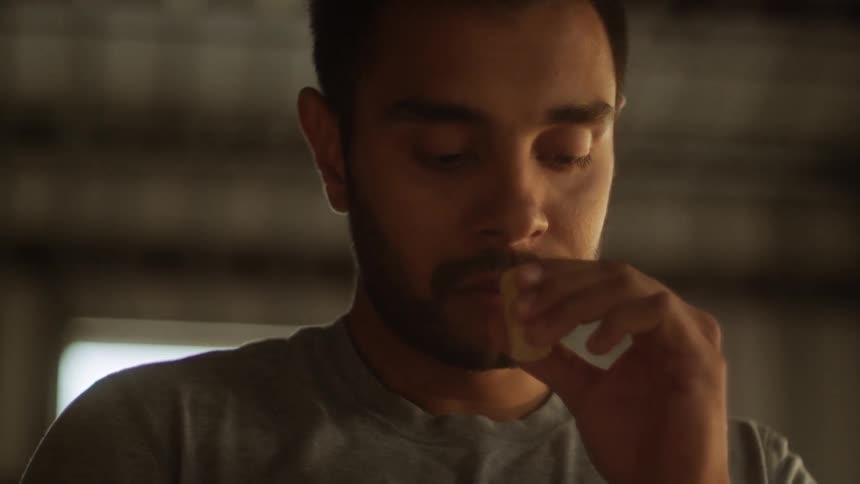 A man smells a small canister