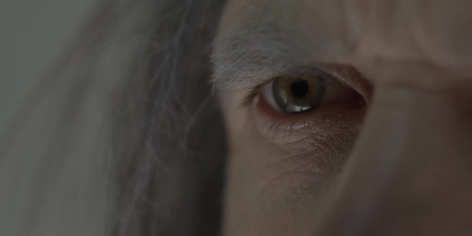 A man's eye widens as he watches something