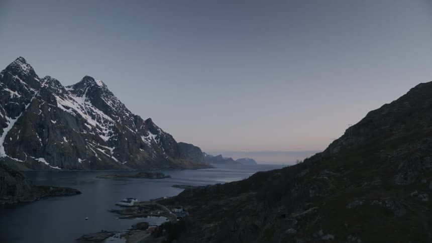 Water sits motionless between mountains