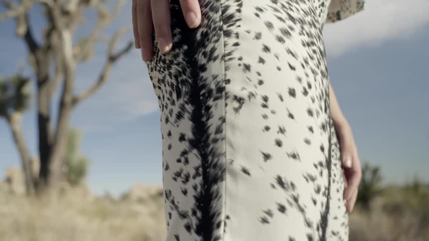 A woman wipes her hand on her leg