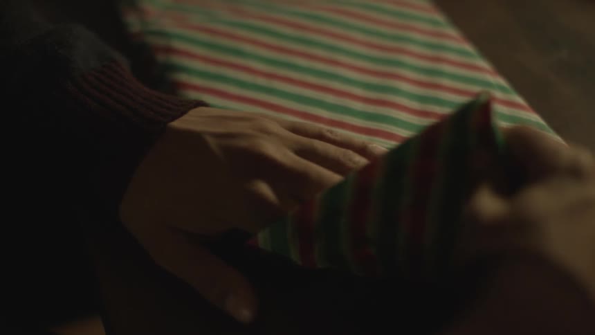 A person wrapping presents
