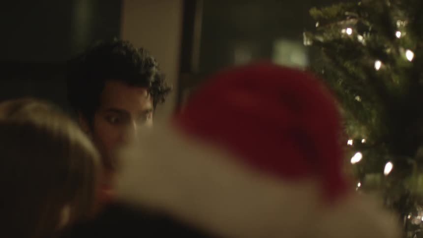People decorate a christmas tree